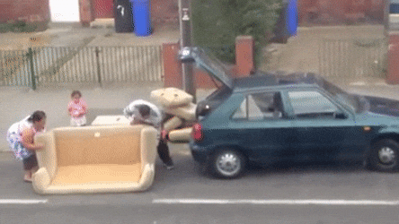 A mover carrying a couch